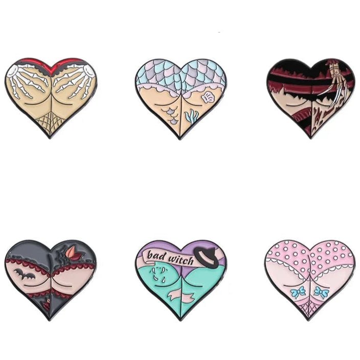 Six heart-shaped pins with unique designs inspired by lace, fishnets, mermaid scales, witch hats, gothic elements, and colorful patterns, arranged in two neat rows of three.