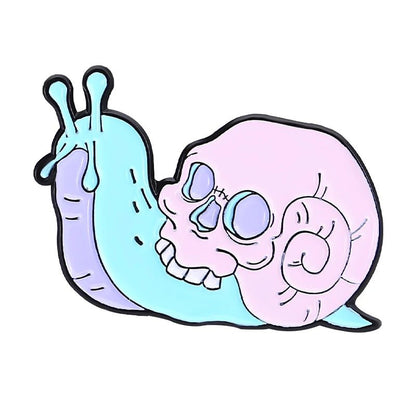 A pastel blue cartoon snail with a pink skull-shaped shell and bold black outlines on white, perfect as a quirky enamel pin 