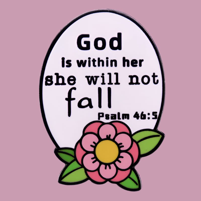 My Cutesy Era’s white oval enamel pin features “God is within her, she will not fall. Psalm 46:5” above a pink flower with green leaves on a light purple background—a floral accessory inspiring faith and strength.