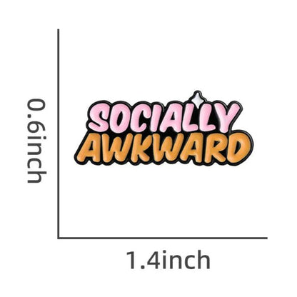 My Cutesy Eras Socially Awkward enamel pin features SOCIALLY in bold pink with a white highlight and AWKWARD in orange. This playful pin measures 1.4 wide by 0.6 tall, perfect for adding fun style to any outfit.