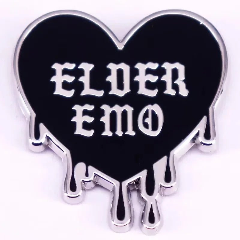 black heart-shaped pin features silver outlines, dripping edges, and bold white Gothic “ELDER EMO” text—perfect for spicing up any Gothic spider pin collection.