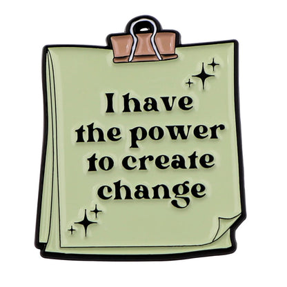 A green notepad features a top clip and the bold words “I have the power to create change,” with three sparkling stars—ideal for daily affirmations and self-empowerment.