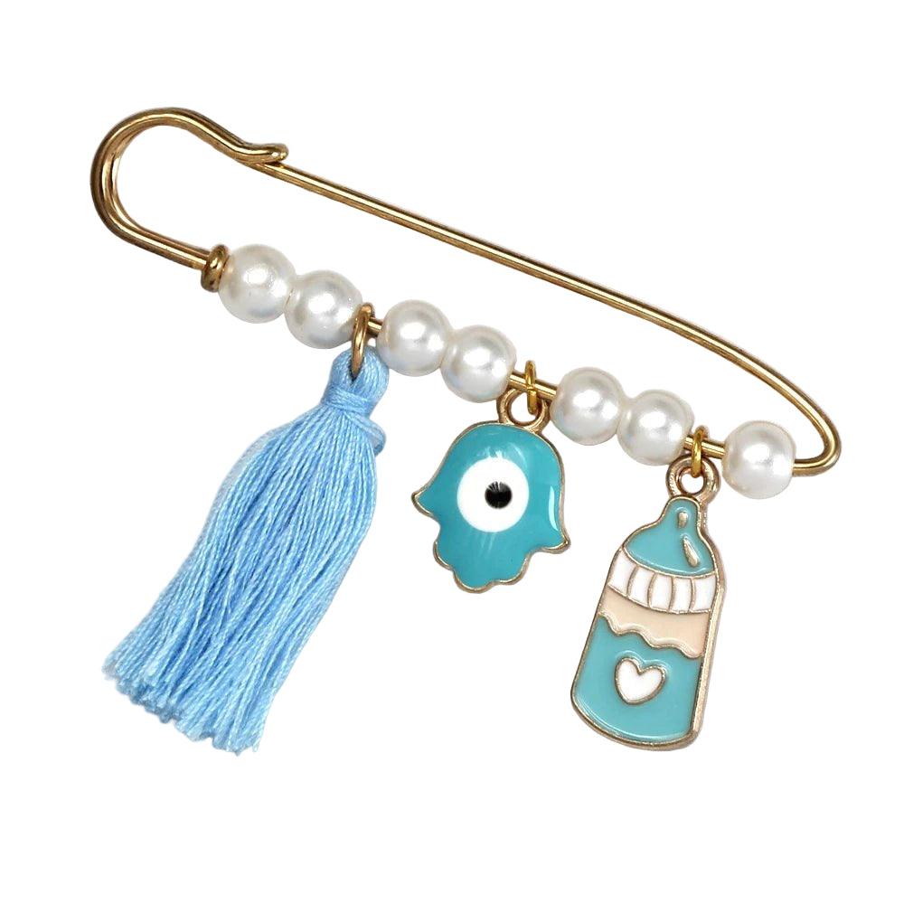 Kiss Me Later gold safety pin brooch features white pearl beads, a blue tassel, evil eye charm, and blue heart baby bottle—making it a unique baby shower gift. Shown on a white background.