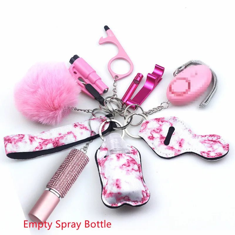 A Kiss Me Later pink and white keychain set with pom-pom, alarms, empty spray bottle, no-touch tool, and beaded lipstick case is displayed on a white background. Text reads: Empty Spray Bottle.