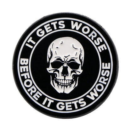 Kiss Me Laters black circular badge gives off spooky vibes, showcasing a white skull in the center with IT GETS WORSE BEFORE IT GETS WORSE boldly written around the edge in white letters.