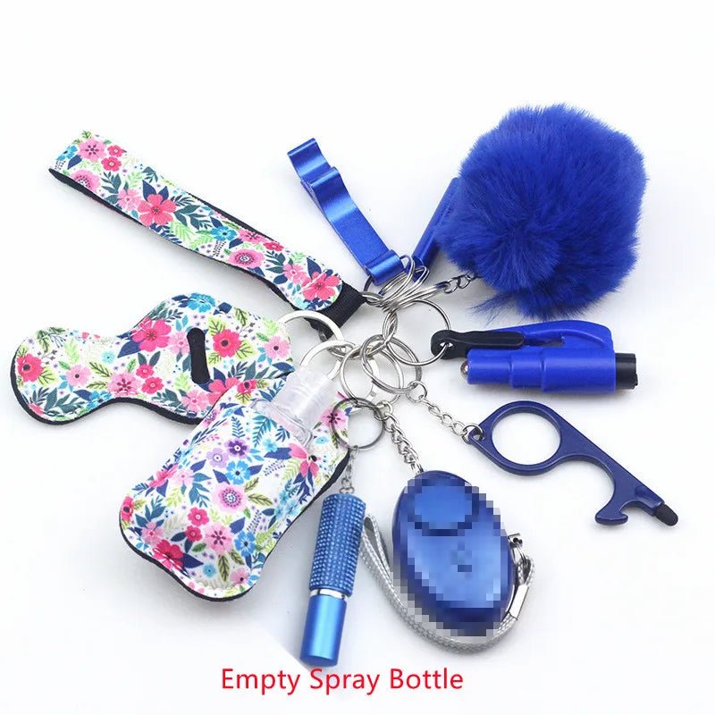 Kiss Me Later keychain set with blue and floral safety accessories—empty spray bottle, fluffy pompom, alarm, touch tool, flashlight, whistle, and zippered pouch—perfect for outdoor adventures. All items are arranged in a circle.