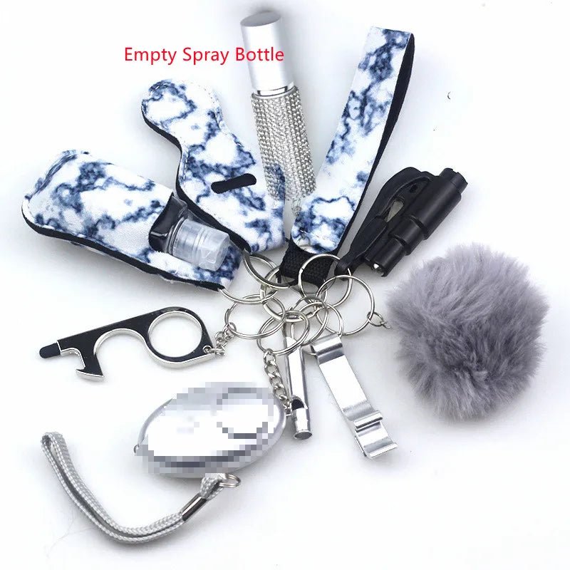The Kiss Me Later keychain set features personal safety accessories—gray pom-pom, marble-patterned holders, whistle, red-labeled empty spray bottle, silver touch tool, alarm, and black tool—perfect for outdoor adventures on a white background.