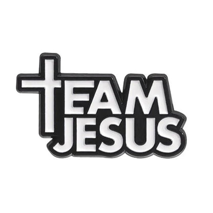 A black and white pin reads “Team Jesus,” featuring a cross-shaped T in Team.