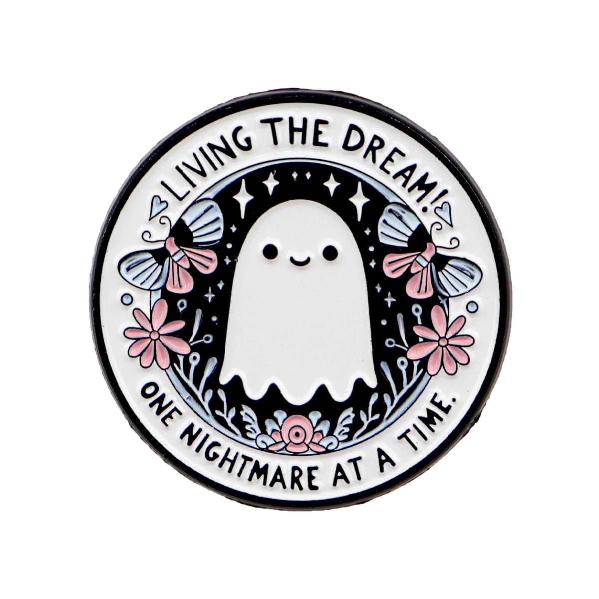 A pin that shows a cute ghost with flowers, stars, and two moths, surrounded by the phrase: LIVING THE DREAM! ONE NIGHTMARE AT A TIME.