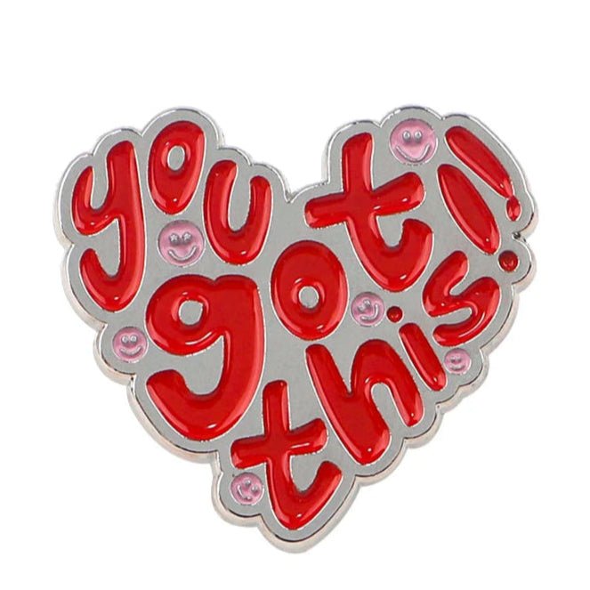 Add some encouragement to your day with this shiny heart-shaped enamel pin from My Cutesy Era! It features bold red bubble letters, you got this! and cute pink smiling faces. Ships worldwide.