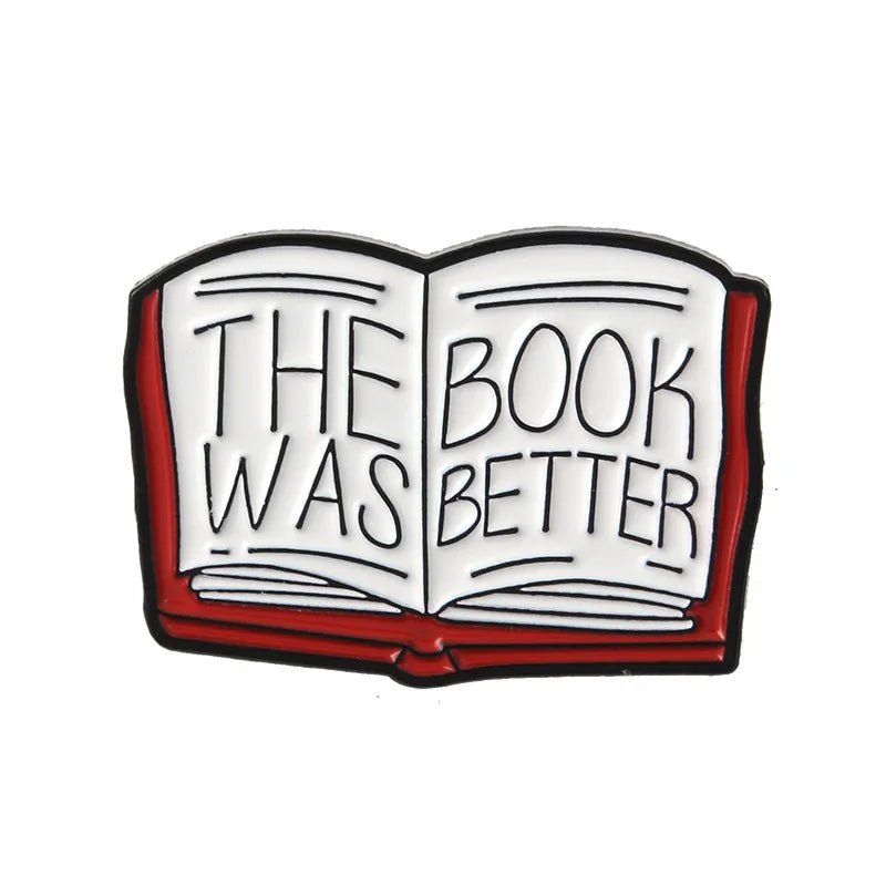 An enamel pin features an open book with THE BOOK WAS BETTER in bold letters, a red cover, and white pages outlined in black—perfect as a Romance Reader gift or badge for any book lover.