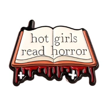 My Cutesy Era’s open book pin reads "hot girls read horror" with blood drips and two white crosses. A unique accessory for bookworms or a fun gift for book lovers.