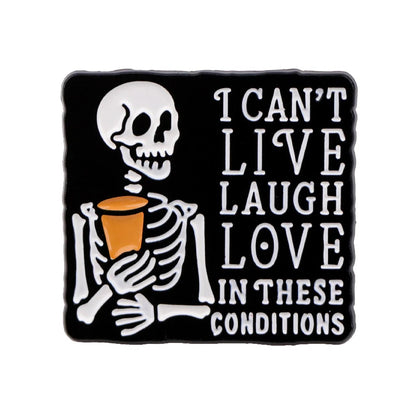A cartoon skeleton with spooky vibes holds a cup beside the text I CANT LIVE LAUGH LOVE IN THESE CONDITIONS, on a black background. Design by Kiss Me Later.