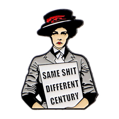 Kiss Me Later presents an illustration of a stern woman in a hat and suit holding a SAME SHIT DIFFERENT CENTURY sign—ideal for a feminist or suffragette enamel pin. Clean white background.