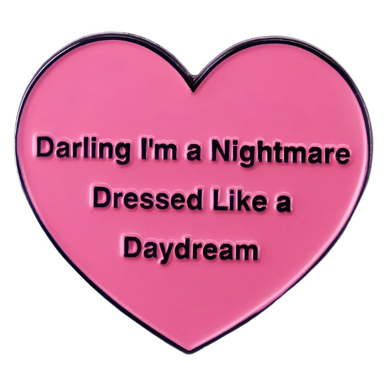 Pink heart-shaped object with text: Darling I'm A Nightmare Dressed Like A Daydream