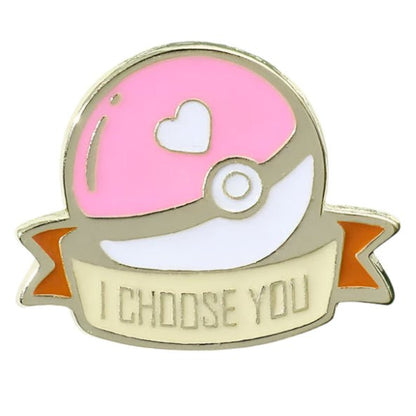 From My Cutesy Era, this pink Poké Ball enamel pin features a heart design and I CHOOSE YOU in gold on a cream-orange ribbon—a must-have for any Pokémon pin collection.