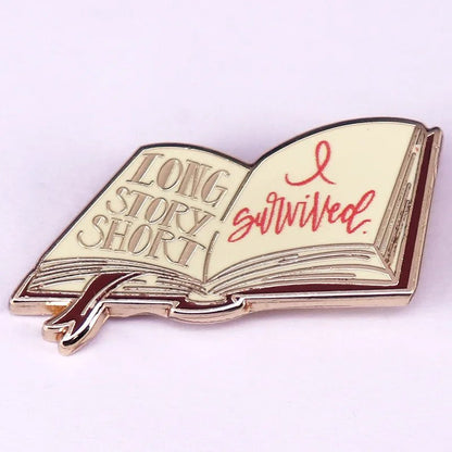 A perfect enamel pin for Romance Readers and book lover badge collectors—this open book design features LONG STORY SHORT and I survived. in red script, with a ribbon bookmark and elegant gold outline.