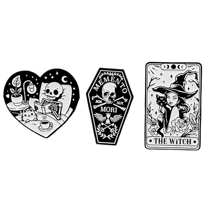 Kiss Me Later: three black-and-white spooky illustrations—a skeleton drinking tea in a heart, a “Memento Mori” coffin with skull, and a tarot-style witch with hat and flowers labeled The Witch.