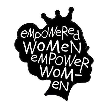 Enamel pin with a woman’s head silhouette, crown, heart, and “empowered women empower women” in bold white on black—perfect for celebrating self-love.