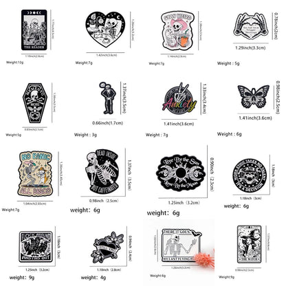A grid of 15 Kiss Me Later gothic enamel pins radiating spooky vibes, featuring designs like skeleton hands, coffins, moths, flowers, and phrases such as “Stay Weird” and “Anxiety,” plus each pin’s measurements and weight displayed below.