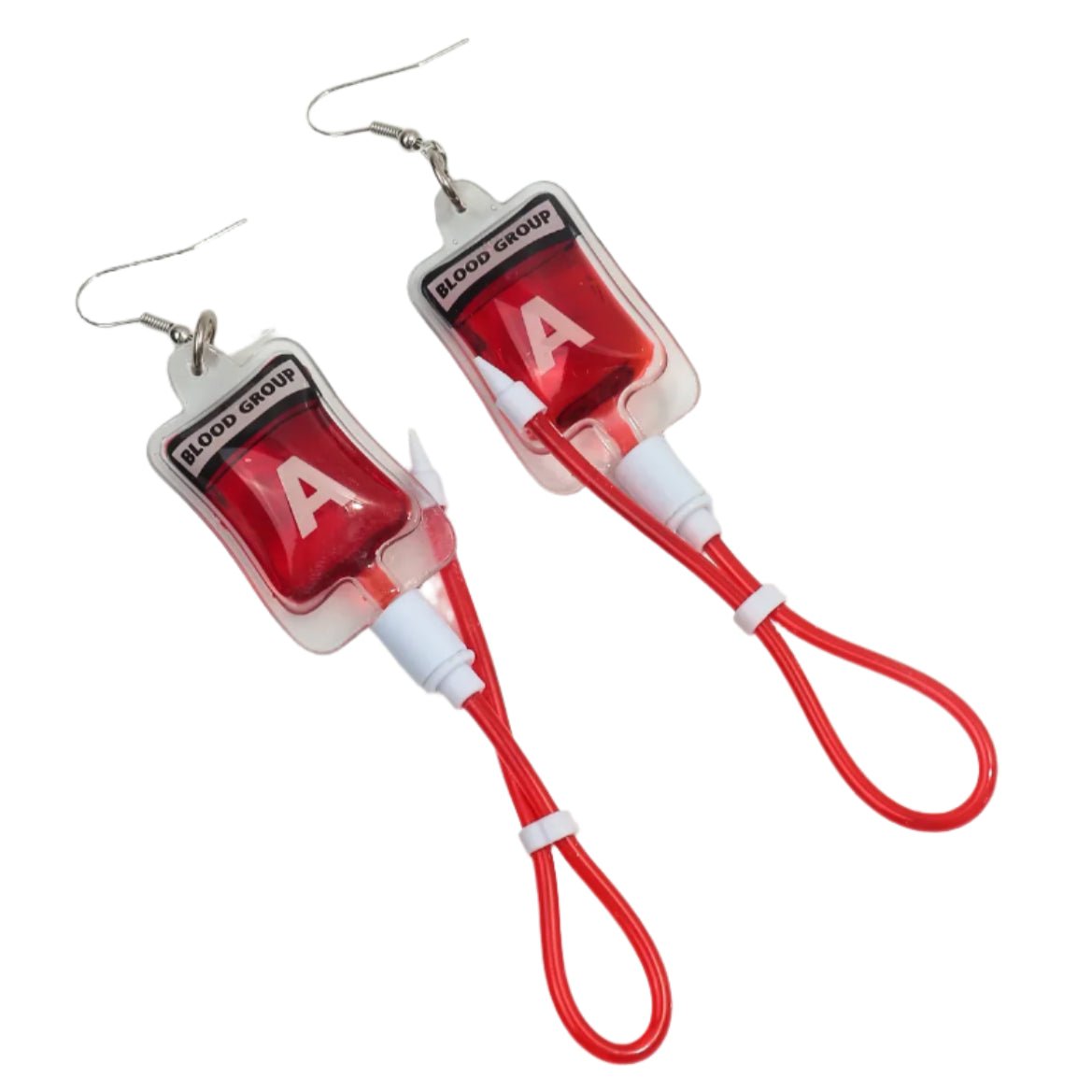 Kiss Me Later’s gothic earrings are shaped like blood bags labeled Blood Group A, featuring red cords that look like IV tubes—an edgy nurse accessory for bold style.