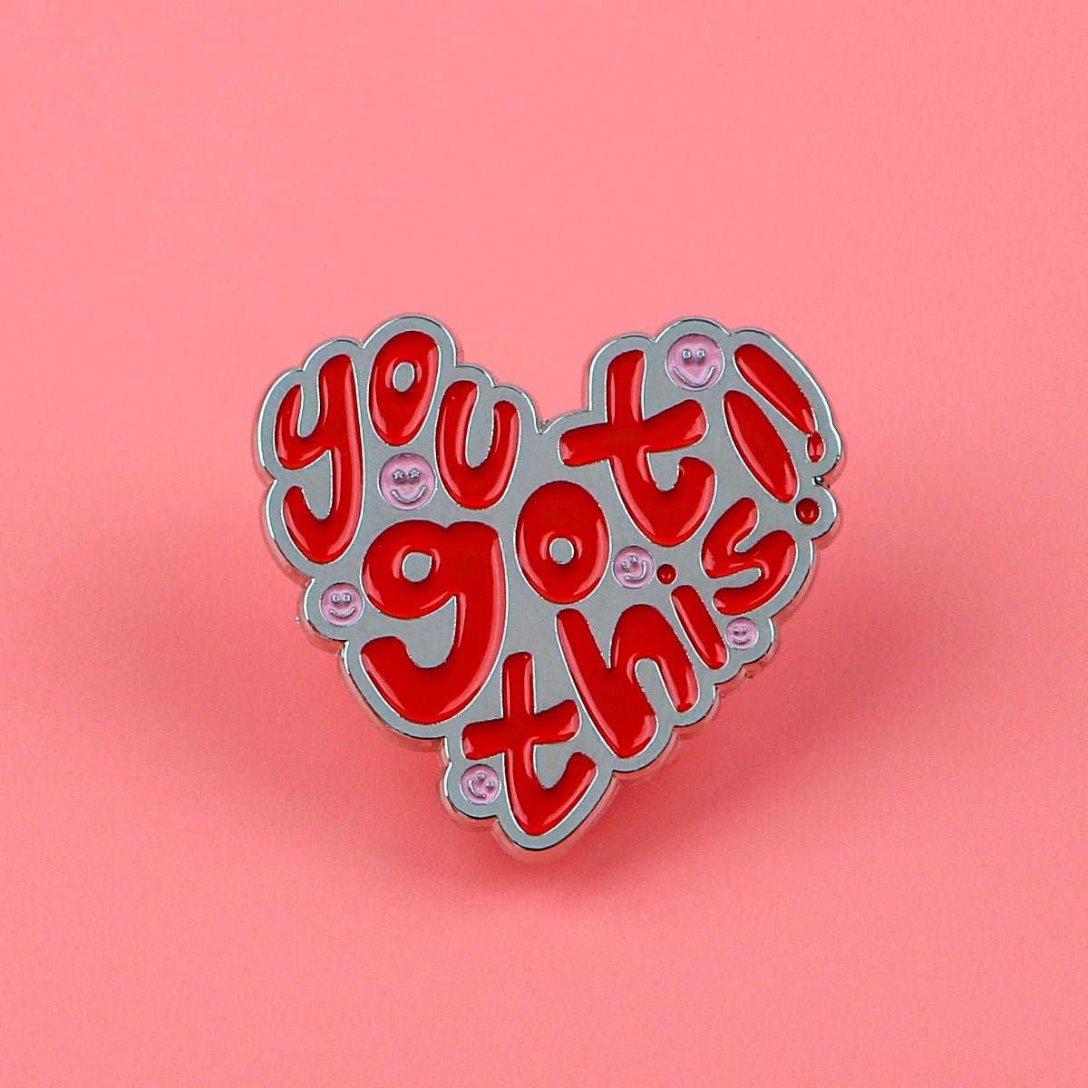 The Kiss Me Later heart-shaped enamel pin features red and pink you got this!! text on a pink background, accented with shiny pink dots—a cute addition to any floral envelope enamel pin collection.