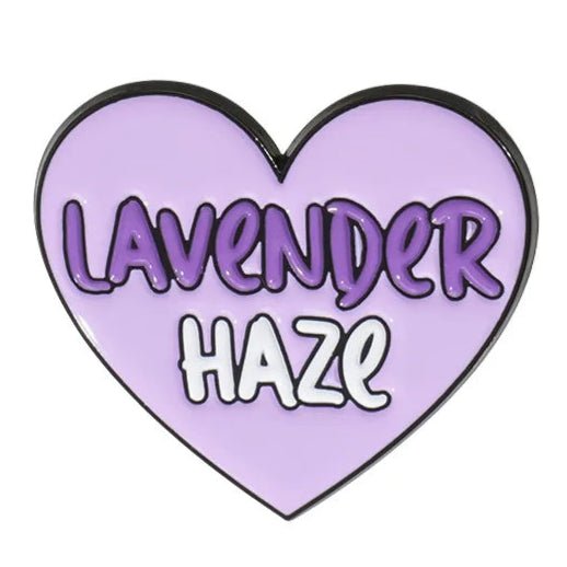A heart-shaped enamel pin with a light purple background, featuring Lavender Haze in bold letters—Lavender in dark purple and Haze in white.