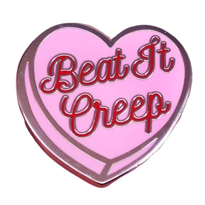 The My Cutesy Era enamel pin features a pink and red heart with bold red outlines and “Beat It Creep” in red cursive—perfect for anyone who loves sassy accessories.