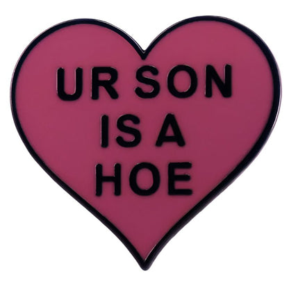Add a cheeky touch to any outfit with My Cutesy Era’s pink heart-shaped Ur Son is a Hoe enamel pin. Featuring bold black text and measuring 1 inch, this fun accessory is sure to stand out.