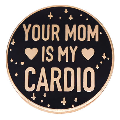 My Cutesy Era presents a black and gold enamel pin with “YOUR MOM IS MY CARDIO,” two hearts, and star accents on a round design.