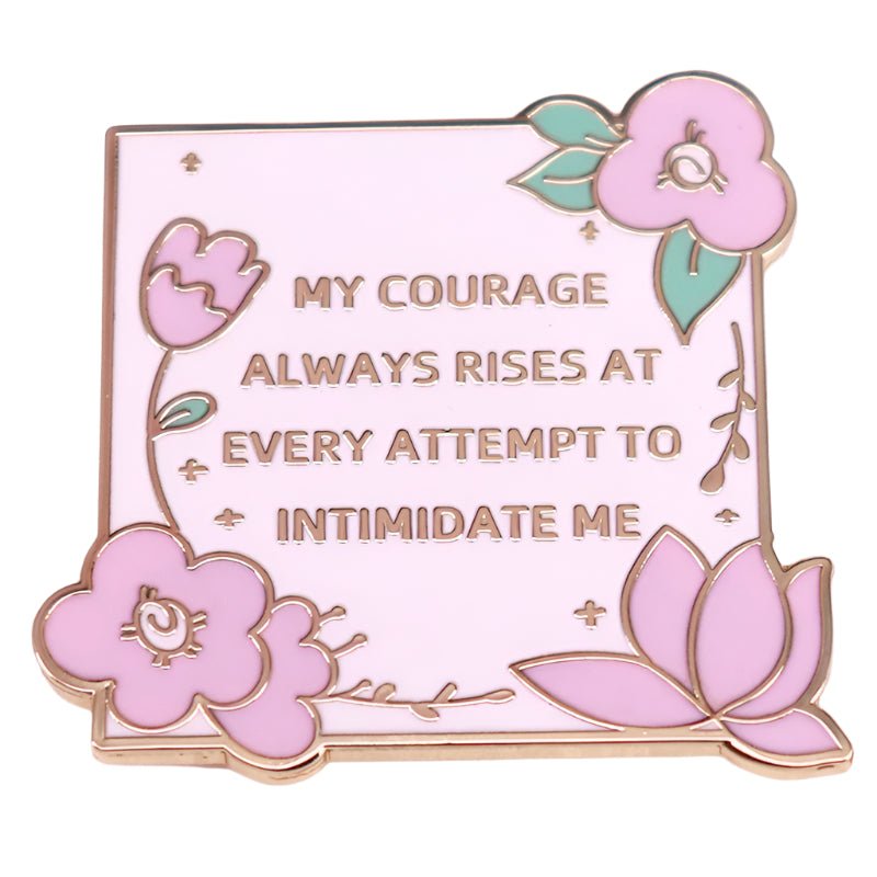 A pink enamel pin by My Cutesy Era featuring Jane Austen, floral accents, green leaves, and the quote: My courage always rises at every attempt to intimidate me.
