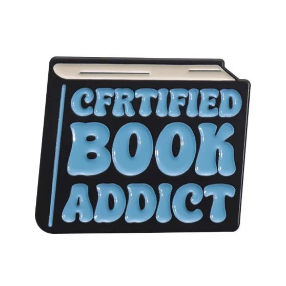 A black and white book-shaped sign with big blue raised letters spelling “CERTIFIED BOOK ADDICT” by My Cutesy Era—a great bookworm accessory or thoughtful gift for book lovers.