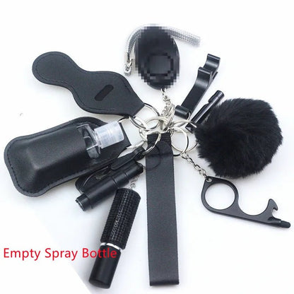 The Kiss Me Later keychain set includes black personal safety accessories: an empty spray bottle in a case, touchless tool, safety alarm, whistle, pom-pom, and chapstick holder. Red text says Empty Spray Bottle.