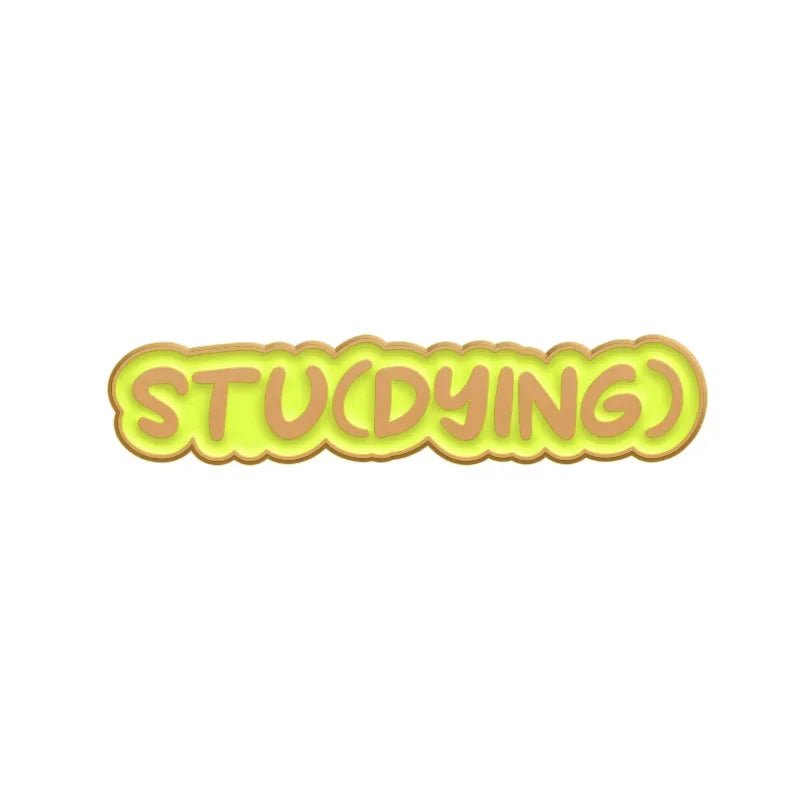 Yellow text on white reads STU(DYING), with DYING in parentheses—wordplay on studying and dying—making this enamel pin a perfect addition to your Cute But Psycho collection.