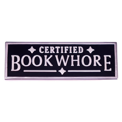The My Cutesy Era Certified Bookwhore enamel pin features a black and silver rectangular design with bold uppercase lettering—perfect for book lovers.