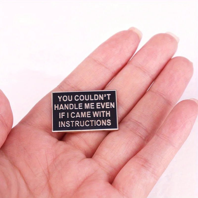 A hand holds a funny black badge by My Cutesy Era with white text: YOU COULDNT HANDLE ME EVEN IF I CAME WITH INSTRUCTIONS