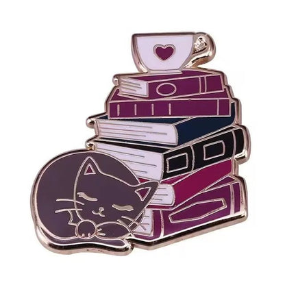 The My Cutesy Era enamel pin features a sleeping cat curled up next to a tall stack of books with a heart teacup on top, in soft purple, pink, and white—an adorable accessory for any book lover.