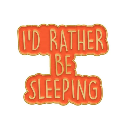A playful orange and yellow badge that says ID RATHER BE SLEEPING—perfect to pair with your favorite enamel pin.