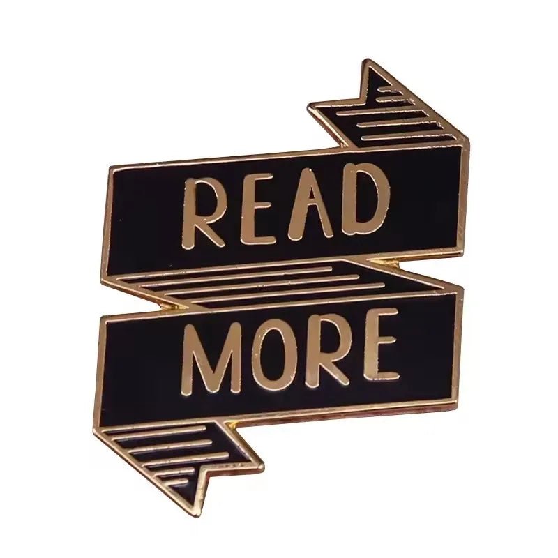The My Cutesy Era black enamel ribbon pin features a gold outline and READ MORE in gold lettering with arrows at each end—perfect for enamel pin collectors and book lovers.