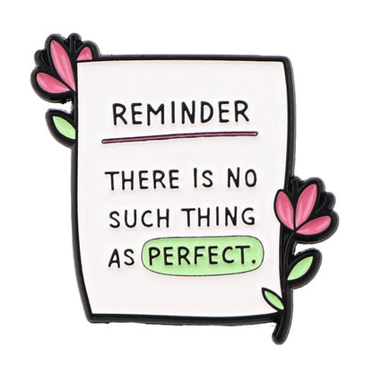 A note badge decorated with pink flowers reads: REMINDER—There is no such thing as perfect, with ‘perfect’ highlighted in green, offering a gentle mental health affirmation.