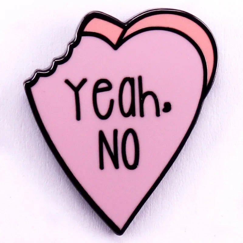 Enamel pin is pink, heart-shaped with a bite mark on the top left, and features Yeah. NO in bold black letters at the center.