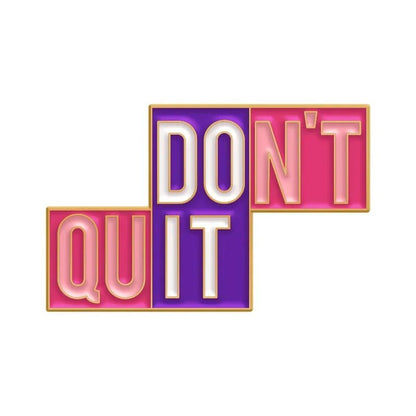 Text graphic: “DONT QUIT” badge in bold capitals—DONT and QUIT in pink boxes, IT in a purple box, all with gold outlining on white. Includes a red heart enamel pin for extra charm.