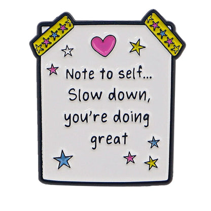 Cute badge features a pink heart, colorful stars, and the message: Note to self... Slow down, youre doing great. Yellow star tape accents the corners—an encouraging reminder for your mental health.