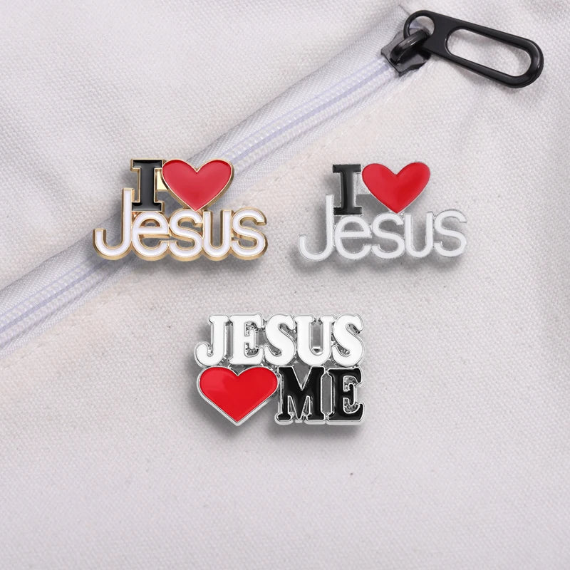 Three Kiss Me Later enamel pins on white fabric—two read I ♥ Jesus in gold and silver, one reads Jesus ♥ ME in silver and black, all with red hearts—great for fans of adorable Christian pins or collectors seeking a unique accessory.