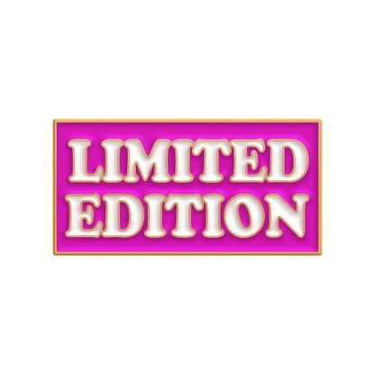 A rectangular badge with a pink background and gold border displays LIMITED EDITION in bold white letters with gold outlining, perfect for showcasing your favorite enamel pins or red love heart pin collection.