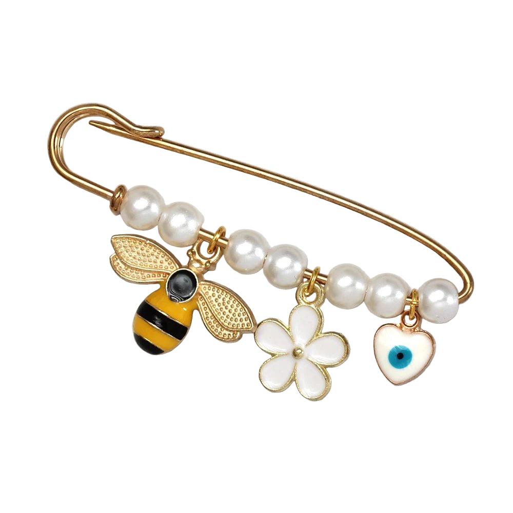 The Kiss Me Later gold safety evil eye pin features white pearls and three charms—a yellow-black bee, a white flower, and a white heart with blue eye—making it a charming beads and charms brooch for any occasion.