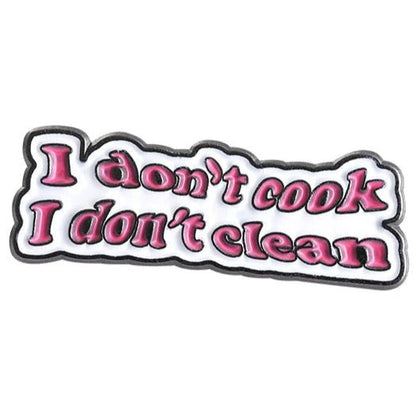 Badge with text 'I don't cook I don't clean' in pink on a white background with black border