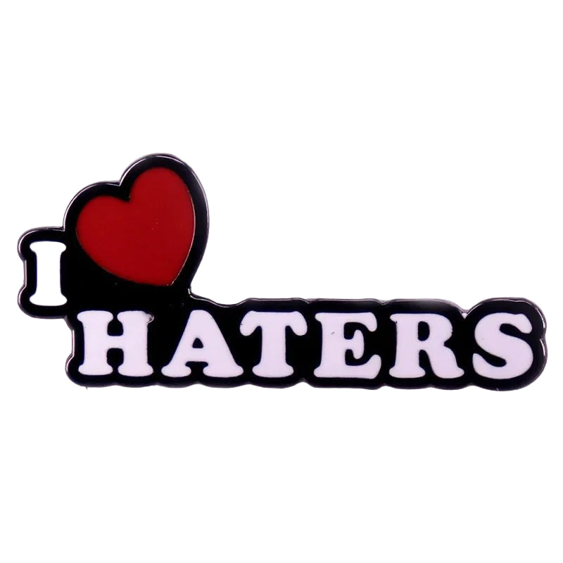 Enamel pin featuring I ♥ HATERS in white letters—the heart in red—set against a clean white background.