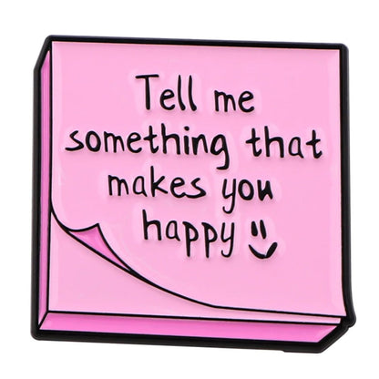 Pink sticky note features Tell me something that makes you happy in handwritten text with a smiley—ideal for sharing positivity, affirmations, or starting mental health conversations.