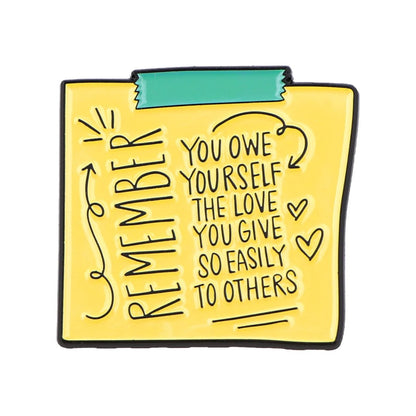 A yellow sticky note with a green top tape reads: REMEMBER you owe yourself the love you give so easily to others, decorated with arrows, hearts, and doodles—an inspiring reminder for self-empowerment.